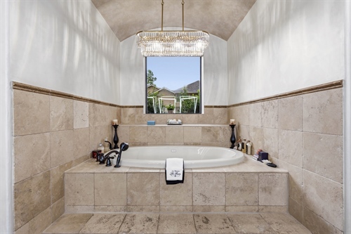 Remote controlled privacy shade at step up bath