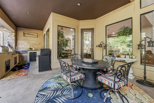 Dine al fresco next to full outdoor kitchen