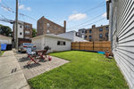 Spacious backyard with brick patio 