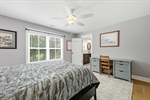 Bedroom three with lighted fan.