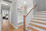 Wood tread stairs lead to the upper level.