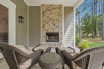 Rear covered porch with fireplace.