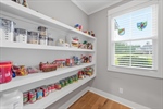 Walk in pantry with built in shelving.