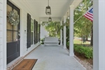 A lovely rocking chair front porch greets you.