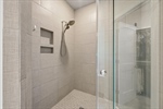 Separate walk in tiled shower.