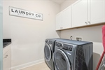 Main level laundry room with built ins.