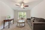 Lighted ceiling fan and large window.