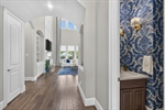 Foyer continues to half bath and family room