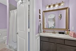 Vanity space connected to bath shared with game