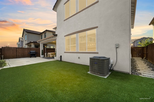 4121 Trinity Alps Way Roseville CA 95747 backyard dusk from grass looking at home gr60vd