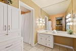 Full bath with a shower make up vanity.
