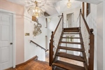 Ascend the stairs to the upper bedroom level.