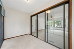 Private primary bedroom sunroom with deck access.