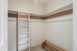 Walk in closet with built ins.
