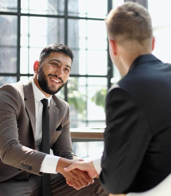 successful businessmen handshaking after good deal