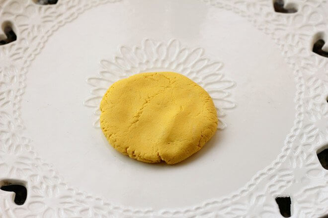 Take a piece of pumpkin dough and knead it into a round ball