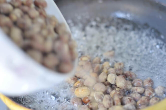 Pour in the fried peanuts and mix well
