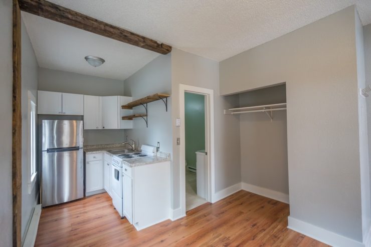 Completed studio apartment. New gray paint, shiny white cabinets, the whole 9 yards.