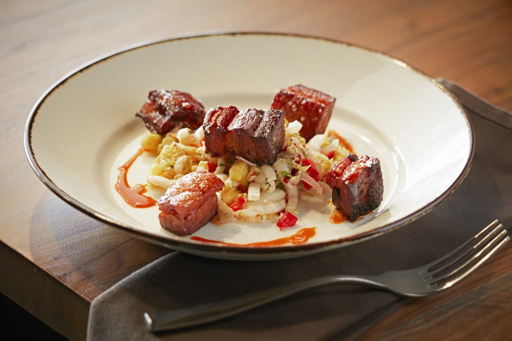 Crispy smoked pork belly drizzled with Cholula, honey glaze pineapple slaw Chef Stephan Pyles Mikael Frey Stampede66