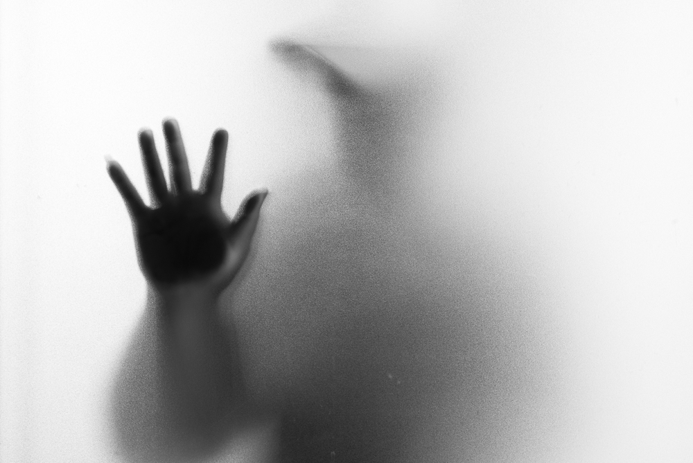 person with hand up