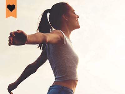 woman standing with her arms out looking exhuberated