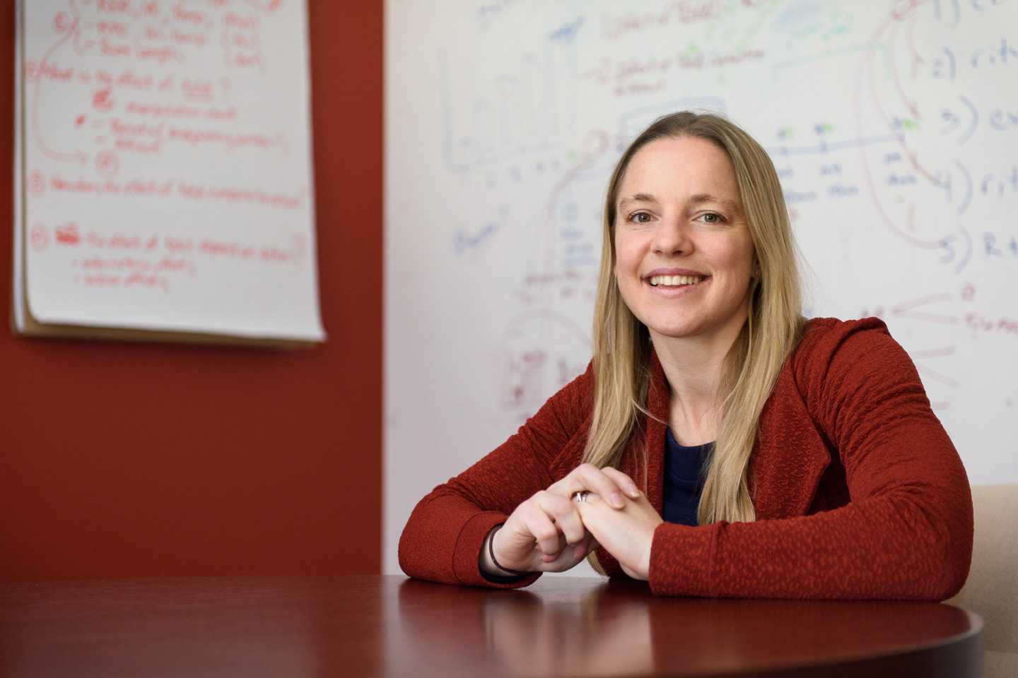 portrait of Alia Crum with whiteboards in the background