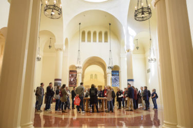 Family members gathered in the rotunda of Green Library for a tour