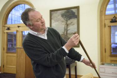 Senior librarian and curator of the sequoia collection Benjamin Stone with a souvenir cane made from a sequoia tree.