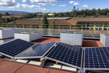 Photovoltaic panels on the roof of Maples Pavilion ready for installation
