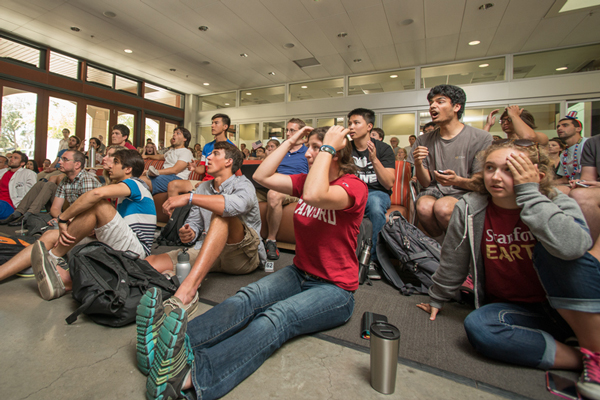 A group of World Cup soccer fans assembled at the large monitor in Y2E2 Tuesday, July 1, to watch the U.S. team play Belgium in an elimination round. The U.S. battled but fell to Belgium 2-1 with all the goals scored in extra time. (Photo: Linda A. Cicero / Stanford News Service)