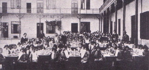 Lunch hour at the "Goutte de Lait" school for orphans in Cairo, founded by Isaac Benarroio in 1917, and directed by his spouse. Was located at the prestigious Kasr el-Nil Street, regarded as one of the best Jewish schools in Cairo, with 800 pupils - girls and boys - who received for free a very high-level education, books, daily meals, clothing, Bar-Mitzva ceremonies, etc. (From the book "The Golden Era of the Jews of Egypt"