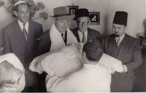 Rabbi Aaron Angel, Vice Chief-Rabbi of Alexandria (on the right), and Salomon Khadour, Director General of Cicurel-Alexandria in the 1950s (on the left), at a ‘Brit Mila’ (circumcision). (From the book “The Golden Era of the Jews of Egypt” by Levana Zamir)