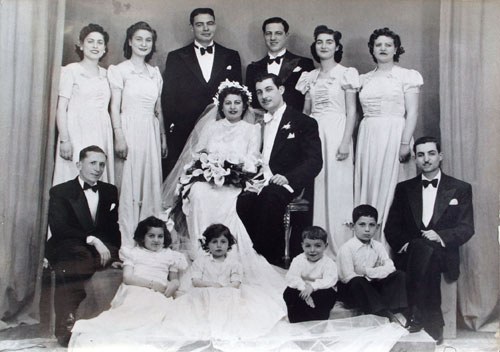 Edward Mosséri and Bella Belbel wedding (1941) at Sha’ar Hashamayim Synagogue, Cairo. With ‘demoiselles d’honneur’ wearing the same long dresses, and their escorts. (Levana Zamir private collection)