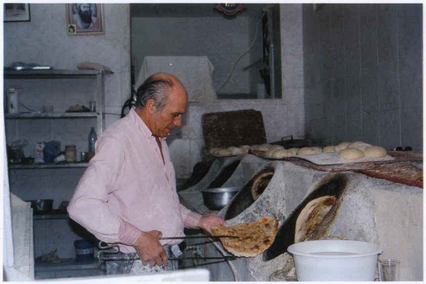 Baker taking Babylonian flat bread out of oven – Daniel Khazzoom