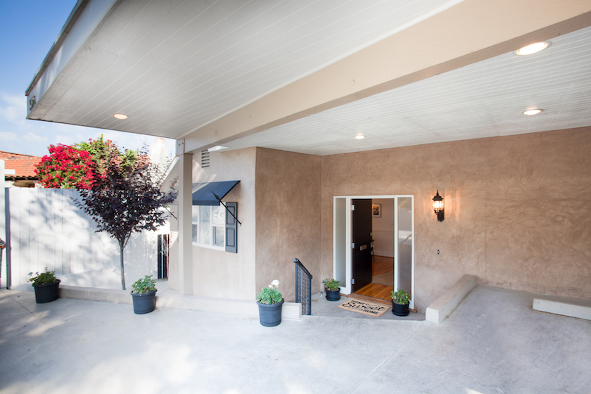 Nestled into a hillside and tucked in by mature trees and bougainvillea