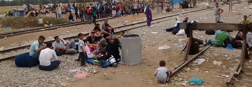 rufugees rest along railroad tracks