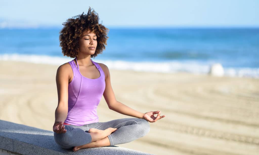 find-the-perfect-style-of-yoga-for-you-woman-doing-yoga-on-the-beach-main-image