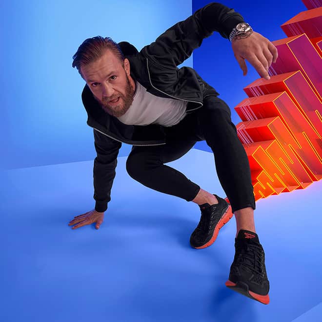 how-to-become-a-legit-runner-mens-running-shoes-reebok-man-showing-off-sports-shoe