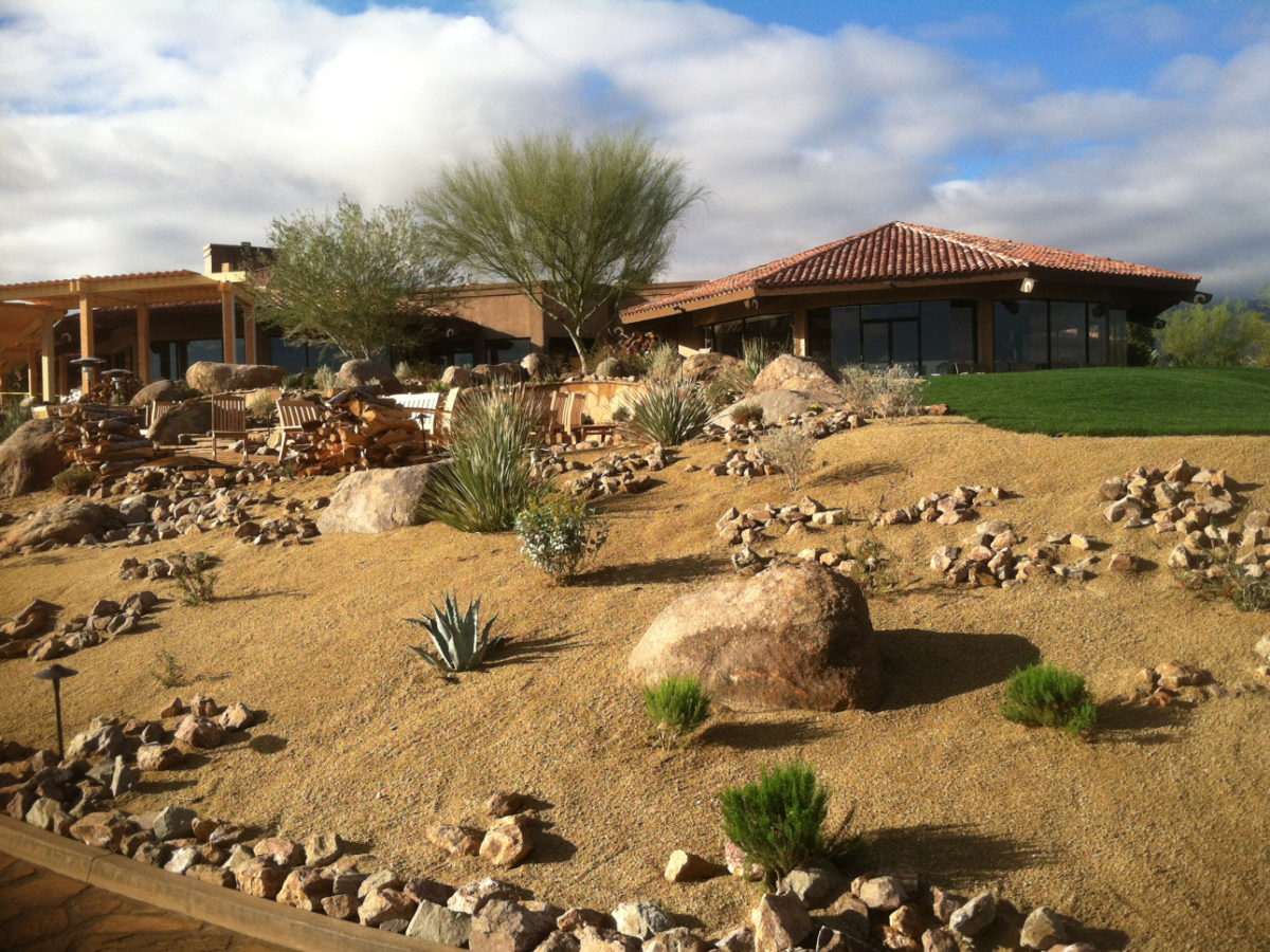 Boulders placed naturally on hillside in front yard