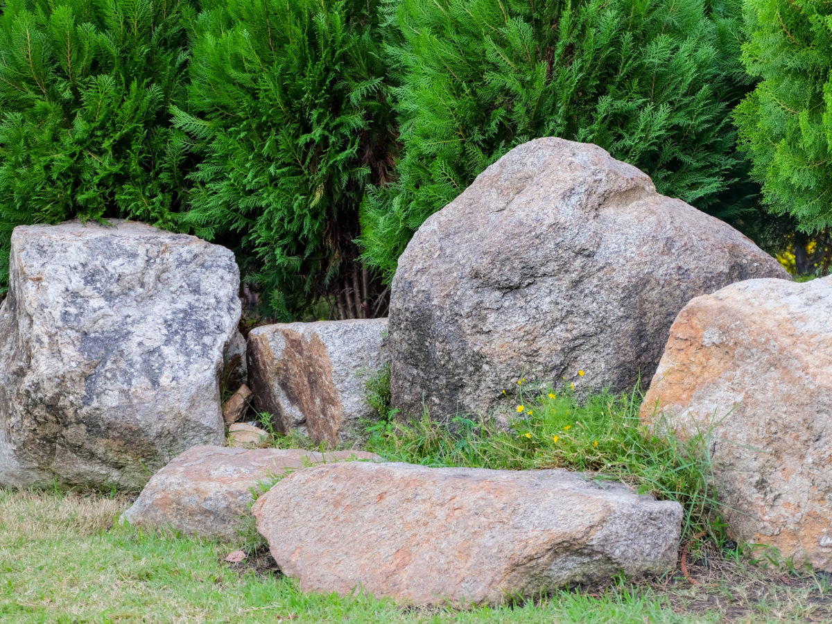 Round boulders next to landscaped grass