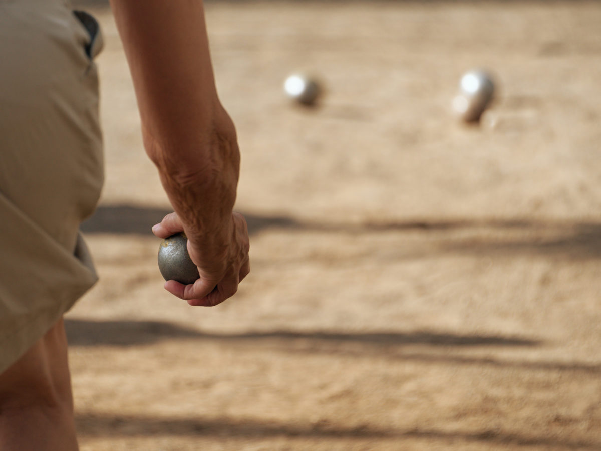 throwing on bocce ball court with top dressing