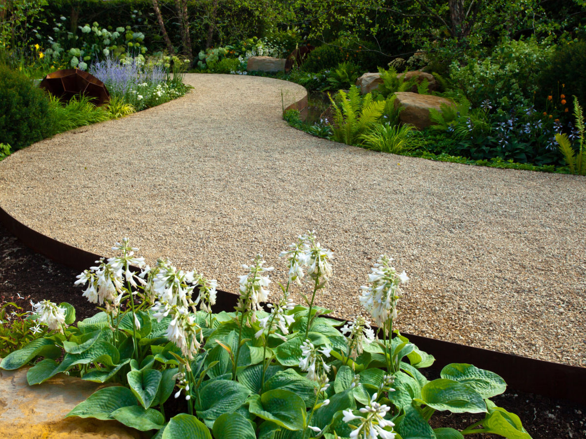 Decomposed granite pathway curved through garden