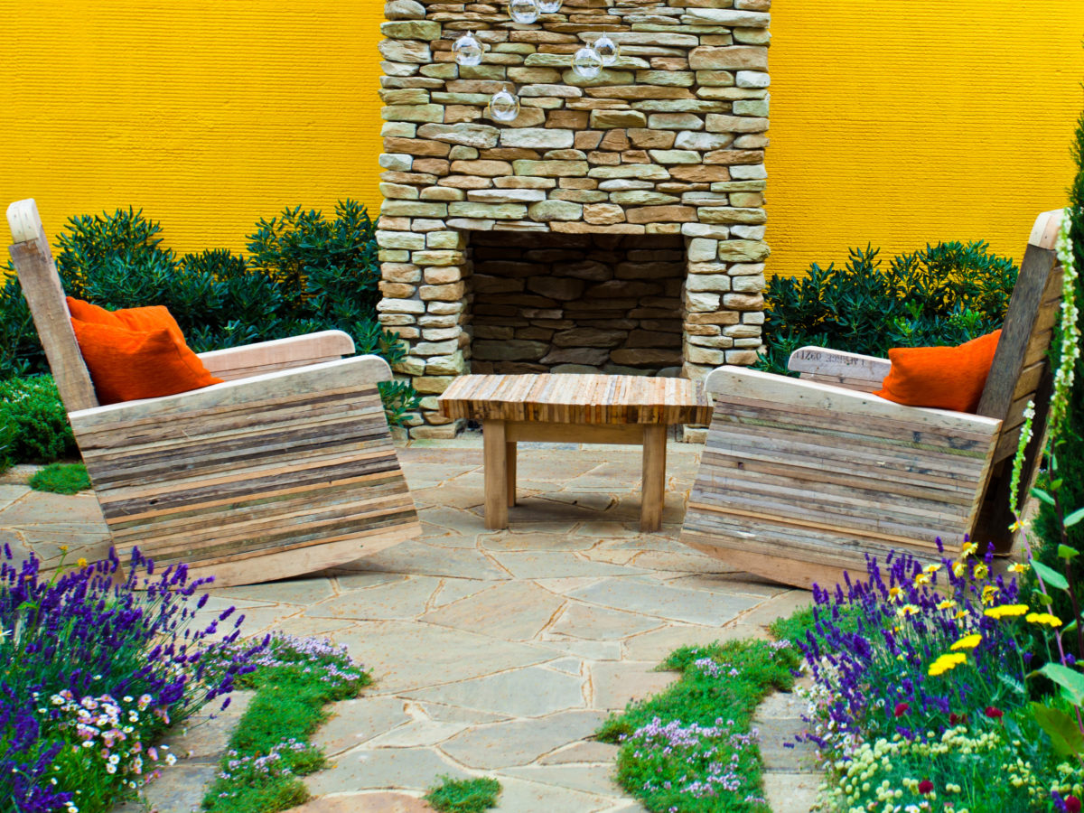 flagstone patio with fireplace and plants