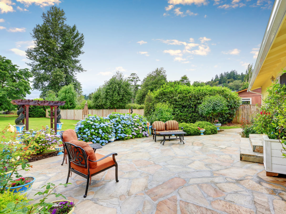 Backyard flagstone patio with furniture