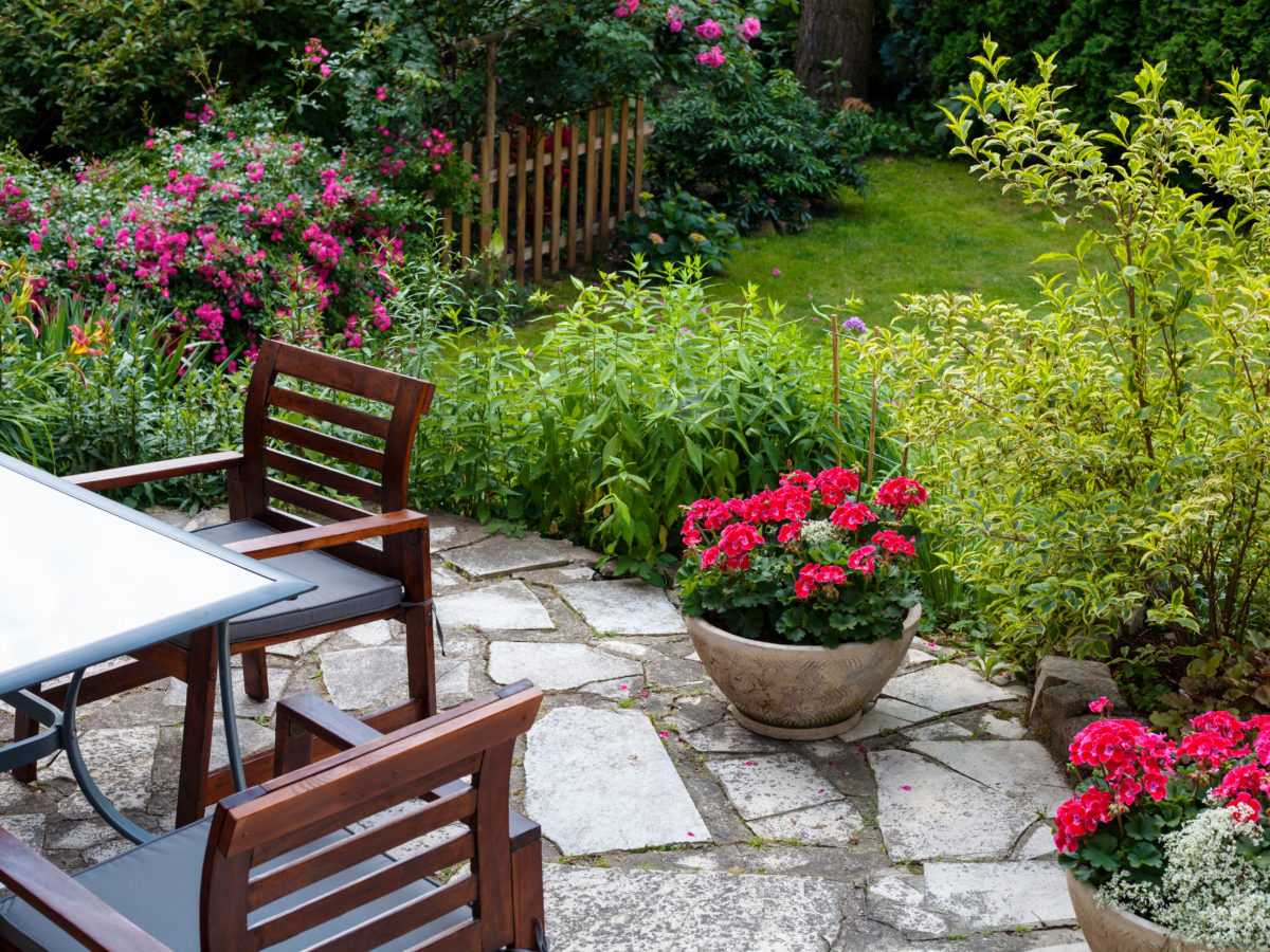 Flagstone patio with potted plants and dining set