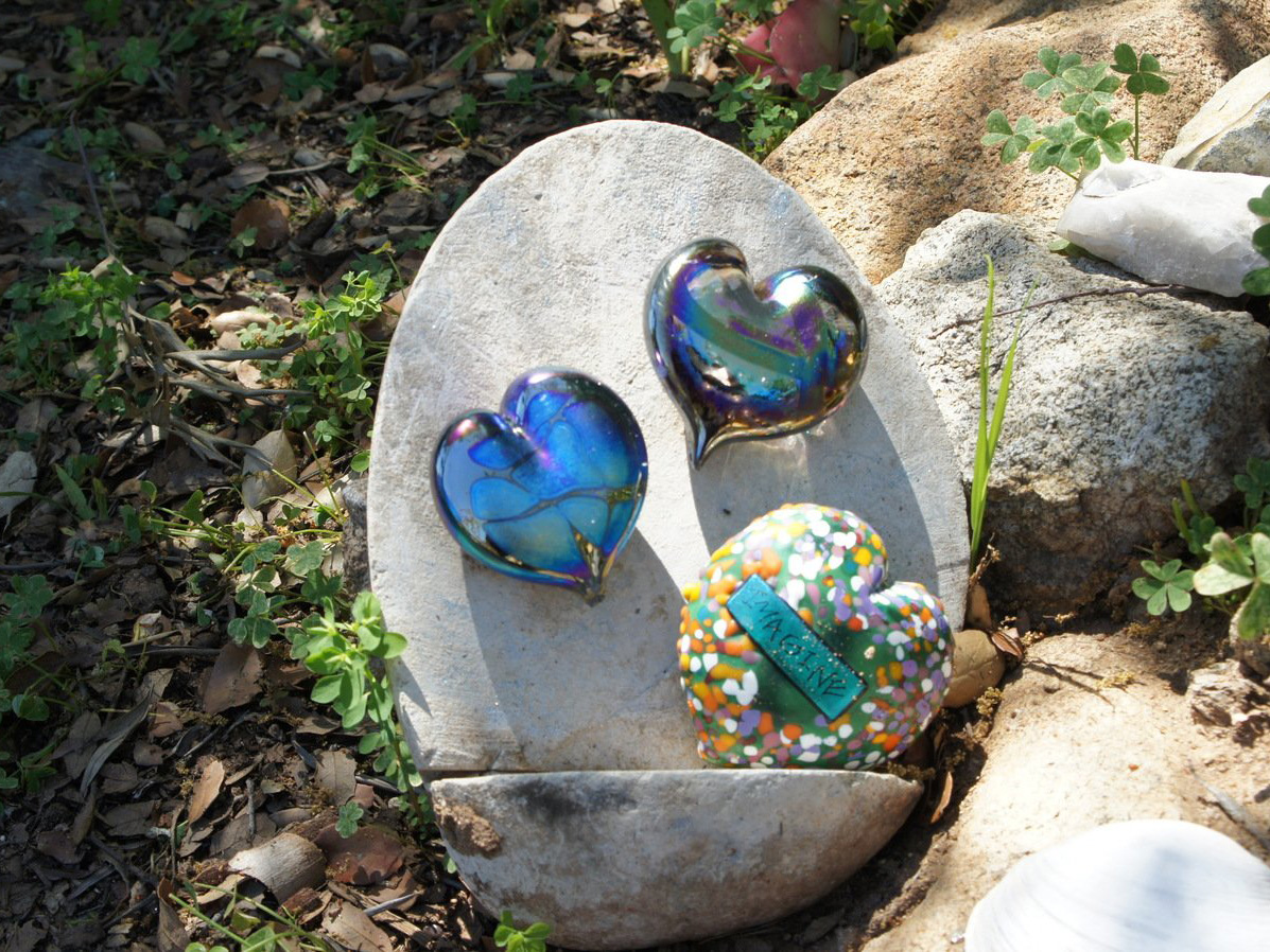 Mosaic rock garden art piece next to pathway