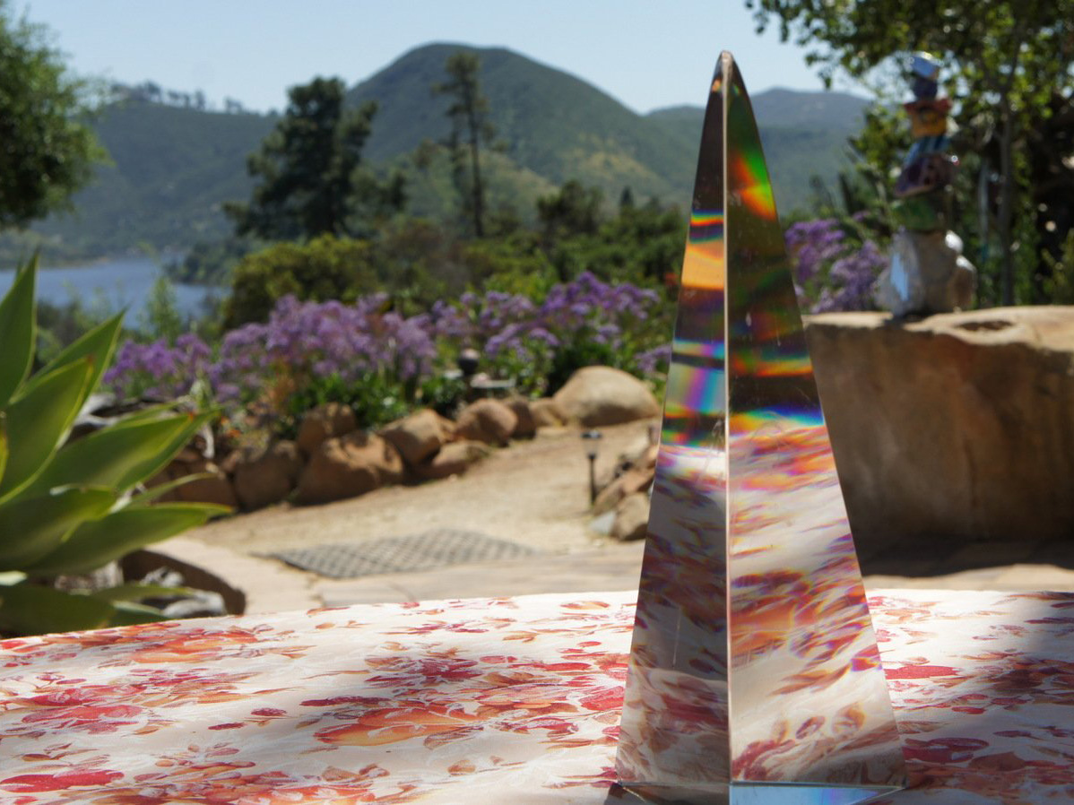 Glass piece on table in mosaic rock garden