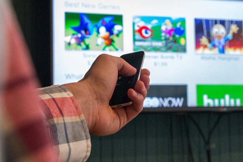 Jon Emminizer showing off the Apple TV. Closeup of Jon Emminizer's hand showing off the Apple TV