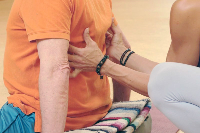Aria Morgan adjusting private client with diaphragmatic breathing, Hands on assist.